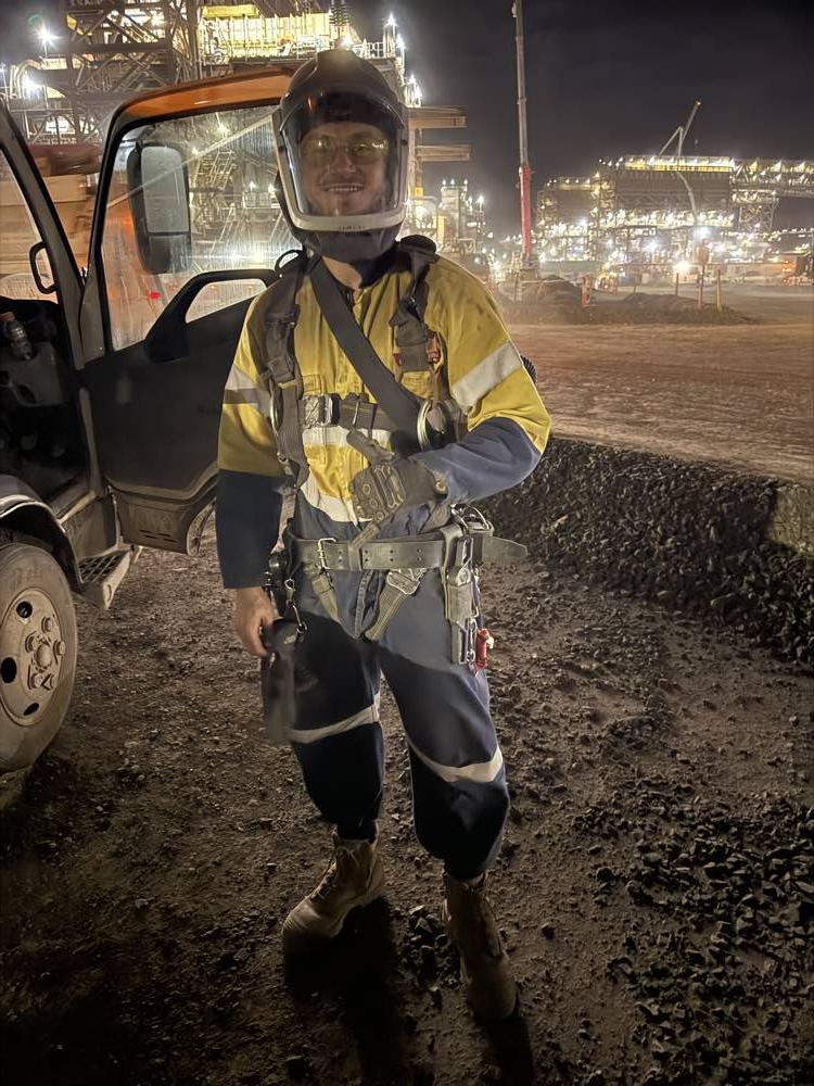 A worker in full protective gear on night shift