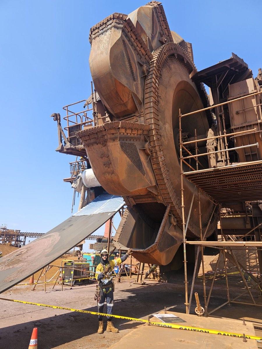 Louis Storath in front of a scaffolded bucket-wheel reclaimer