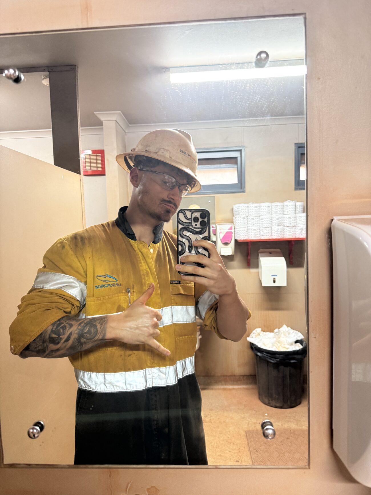 Louis Storath in camp, still in his hi-vis work gear, hard hat and safety glasses
